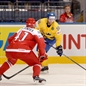 MINSK, BELARUS - MAY 10: Sweden's Linus Klasen #86 looks for a pass with pressure from Denmark's Jesper B. Jensen #41 during preliminary round action at the 2014 IIHF Ice Hockey World Championship. (Photo by Richard Wolowicz/HHOF-IIHF Images)